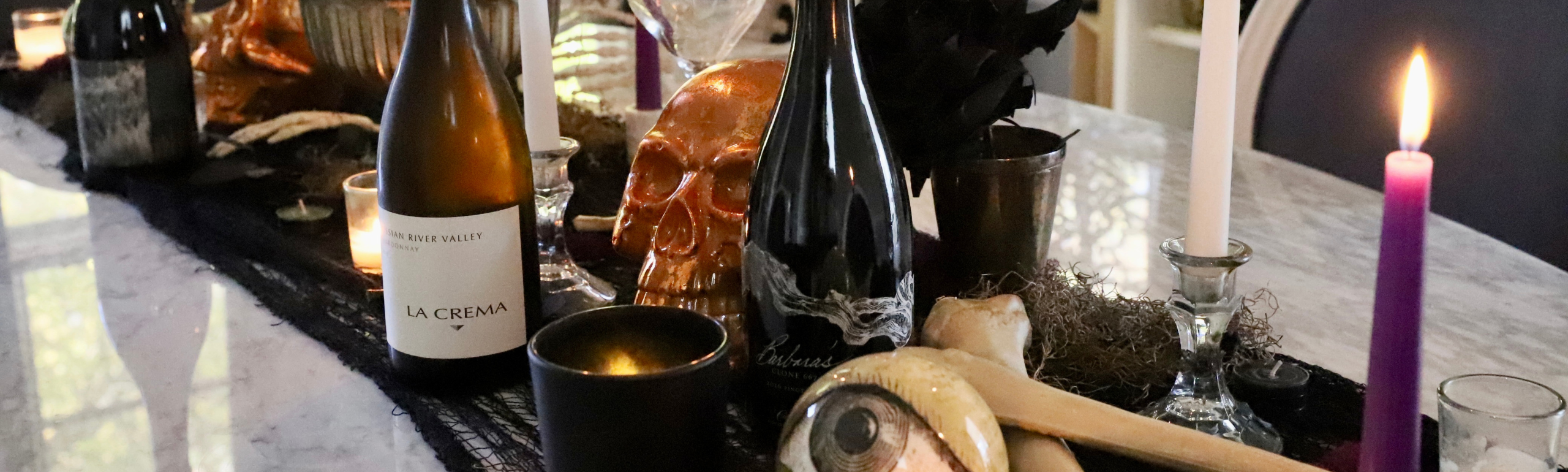 Bottles of wine on a spooky Halloween themed table set